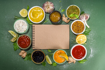 Assortment of different classic sauces and dips in sauceboats. Mayonnaise, ketchup, tartare, mustard, pesto, sour cream, barbecue sauces with spices, herbs, lemon