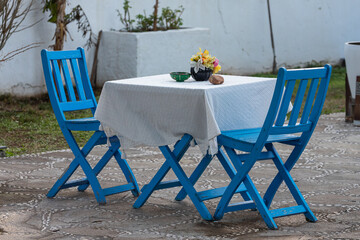 The concept of a measured rest on the seashore. The perfect place for a date. Restaurant with blue wooden furniture