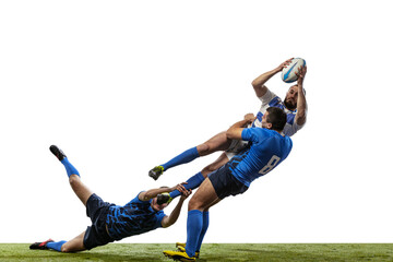 Sportive men, professional rugby players playing rugby football on grass field isolated on white background. Sport, activity, health, hobby, occupations concept © master1305
