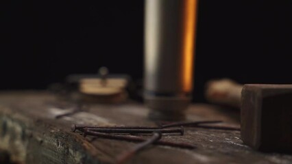 Rusty nails falling on wooden plank table in slow motion - Powered by Adobe