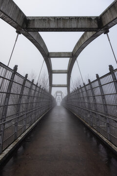 Pedestrian bridge over the Trans-Canada Highway 1 during a winter foggy morning. Surrey, Greater Vancouver, British Columbia, Canada.