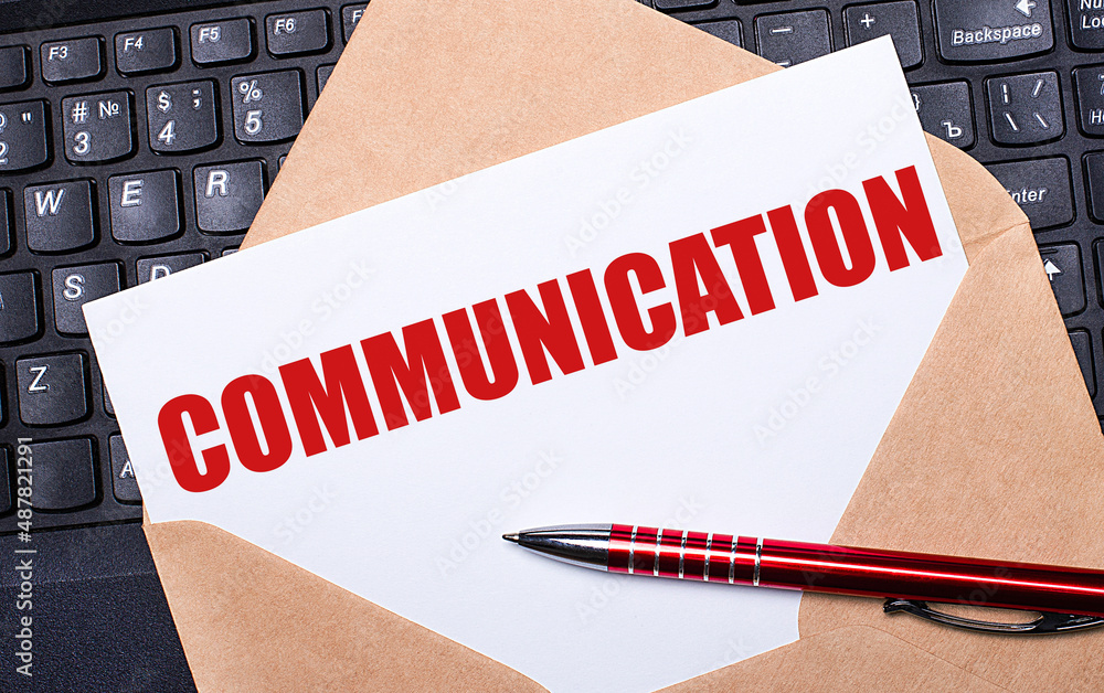 Poster white card with the text communication in a craft envelope on a work desk with a modern laptop keybo