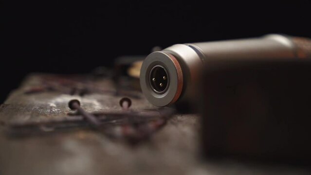 Camera pan on the xlr jack of a condensor microphone lying on a wooden table