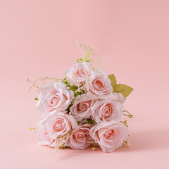 Bouquet of fresh pink roses on a square pink background