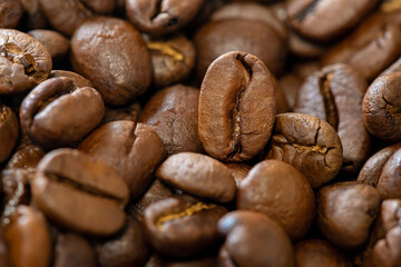 Aromatic roasted coffee beans close-up. Macro, soft selective focus.