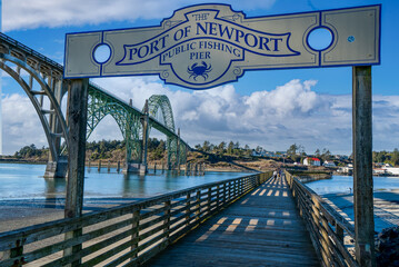 Port of Newport public fishing pier with yaquina bay bridge, at Newport Oregon - obrazy, fototapety, plakaty