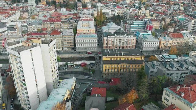 Drone shot of the Bosnian capital Sarajevo. In the front you see the famous parrot building and behind it the colorfull tram of this city.
