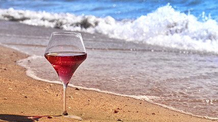 Wine glass with a cocktail by the sea.