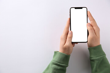 Man with smartphone on white background, top view. Space for text