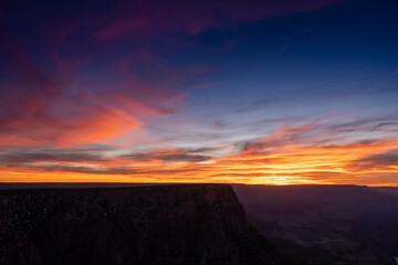 The Edge of the Grand Canyon Drops Off below sunset colors
