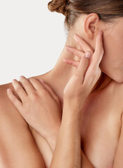 Reveling in her softness. Closeup studio shot of a beautiful young woman caressing her skin.