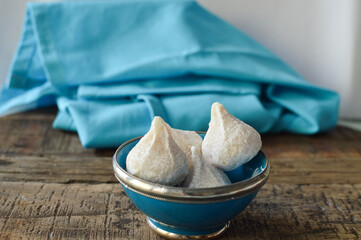 Amygdalota, traditional Greek almond cookies from Cyclades, Greek blue kitchen cloth in the background
