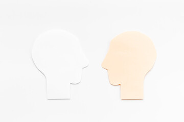 Human communication concept with two paper human heads