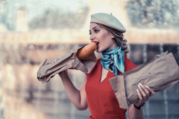 girl with a baguette on the background of the fountain