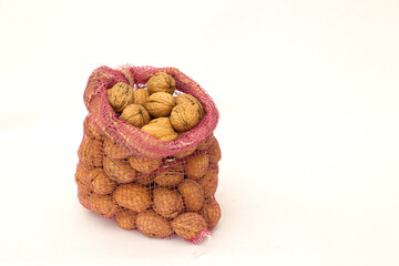 organic wallnuts nut package in sack situate isolated on white background. fresh natural vegetarian food healthy, hard oval nutshell wallnut
