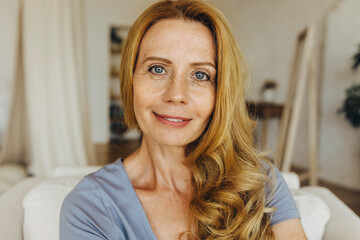 Caucasian adult woman of 50s wearing no makeup up, having natural beauty, perfect ageing face skin,...