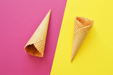 two waffle cones on a geometric bicolor background