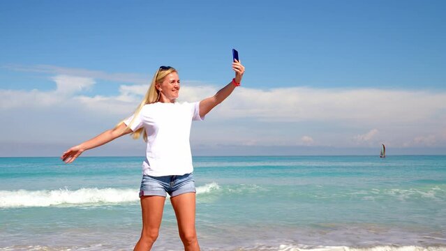 travel, tourism, emotions, expressions and people concept - happy smiling young woman taking selfie over exotic tropical beach background.