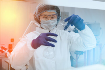 Scientist or medical nurse holding a glasses test tube in a scientific medical science laboratory.  