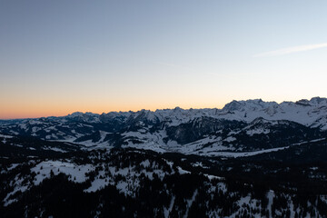 Amazing sunrise with red sky and a beautiful landscape in the wonderful region in Switzerland called Mythenregion. Beautiful mountain called Mythen and an epic sea of fog in the background.