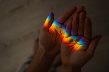 Rainbow ray on a woman's hand. 