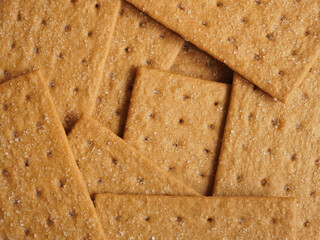 Closeup, flat lay, seamless image of crisp, sugar-coated coffee biscuits.