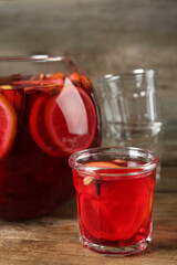 Aromatic punch drink with citrus fruits on wooden table