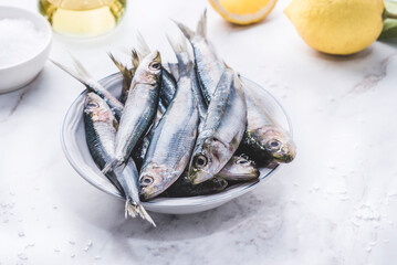 Fresh sardines served with lemons and olive oil. Fish is full of omega3 