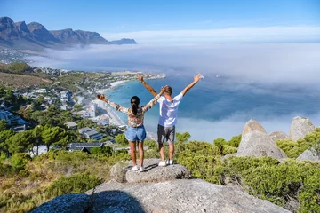 Wall murals Table Mountain View from The Rock viewpoint in Cape Town over Campsbay, view over Camps Bay with fog over the ocean. fog coming in from ocean at Camps Bay Cape Town