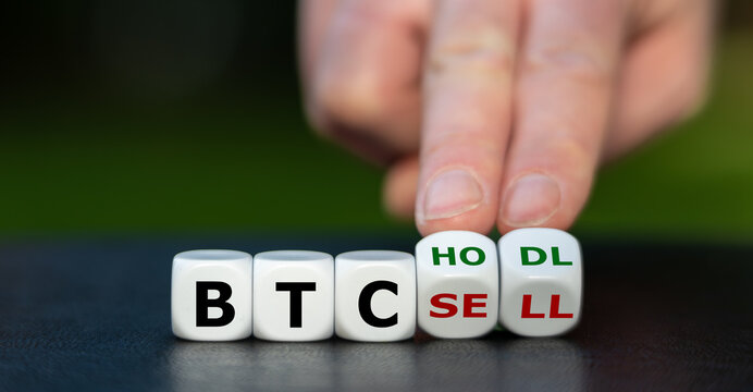 Symbol for keeping (hodl) Bitcoins (BTC). Hand turns dice and changes the expression "BTC sell" to "BTC hodl".
