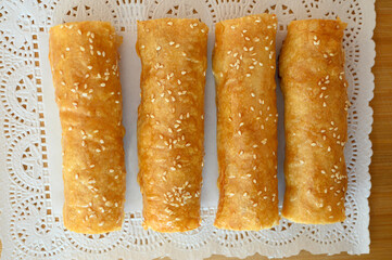Iconic rustic Romanian and Moldavian pies with white seeds, spinach and cheese filing.