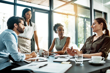 No idea is left behind. Shot of a group of colleagues having a meeting in a modern office.