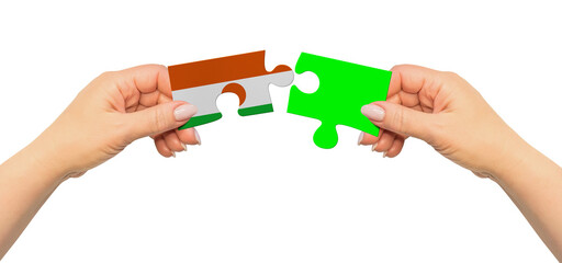 Woman hands are holding part of puzzle game. National mock up on white background. Niger