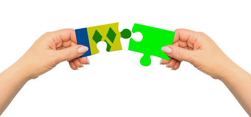 Woman hands are holding part of puzzle game. National mock up on white background. Saint Vincent...