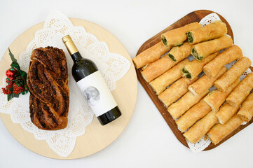 Romanian Easter Bread- Cozonac with wine and Romanian pies on the side.