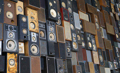 Maastricht, Netherlands - February 13. 2022: View on isolated wall many stacked music vintage loudspeaker boxes - obrazy, fototapety, plakaty