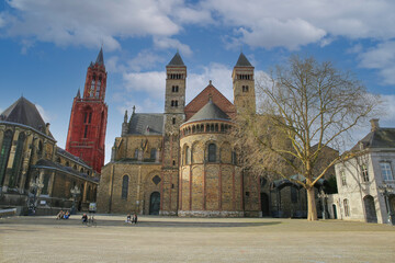 Fototapeta na wymiar Maastricht, Netherlands - February 13. 2022: View over square on saint servatius basilica and st johns church against blue winter sky