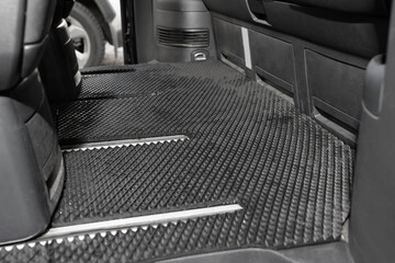 Black rubber car floor mat in auto