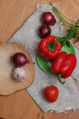 Red sweet pepper on a cutting wooden board.