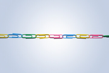 Multicolor paperclips on a fresh look white background, paperclips chain represent teamwork and connectivity
