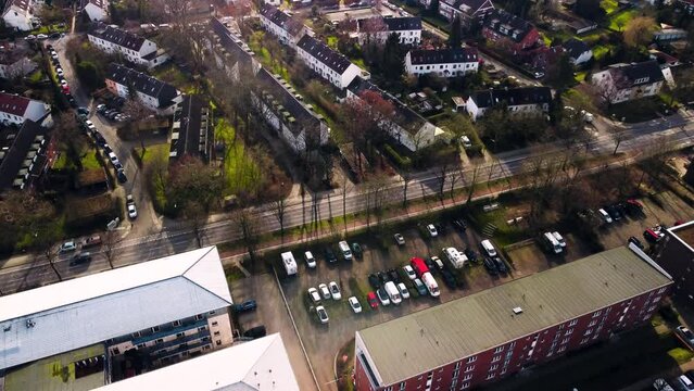 Aerial view of car driving over empty suburban road