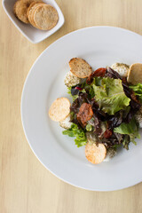 Green and purple lettuce salad. Arugula and pieces of casabe. Healthy food.