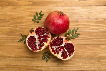 Fresh juicy pomegranate on wooden background, top view