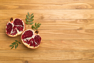 Fresh juicy pomegranate on wooden background, top view