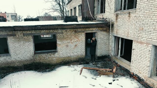 A man with an anti-tank weapon in an abandoned house. Civilian population with weapons to destroy tanks.
