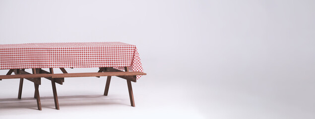 Picnic table and red checkered tablecloth with food and drink for outdoor party. Isolated white...