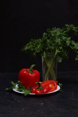Red bell pepper close-up on a black background. Pod of sweet red pepper on a black background.