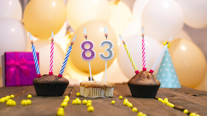 A beautiful birthday card for a woman with the number 83 in a cupcake against the background of...