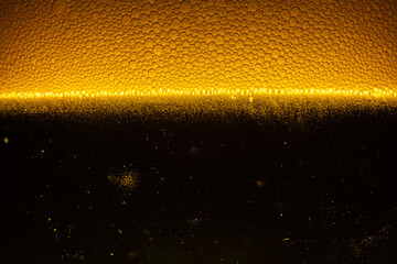 Close up of the beer,Close up in foam and bubbles of beer on black background,Water drops background 