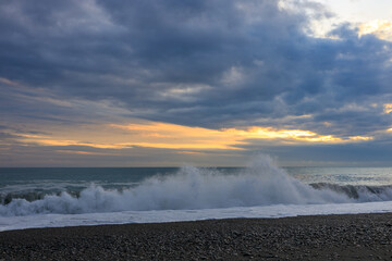 big waves roll on the seashore, sunset on the sea